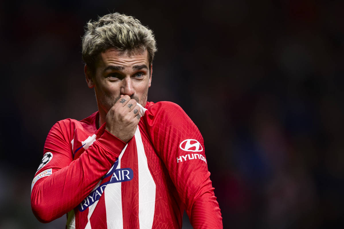 Antoine Griezmann pictured kissing the Atletico Madrid crest on his jersey after scoring a goal in a 2-0 win over Lazio in December 2023